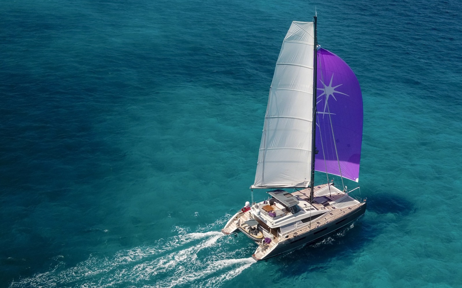 Sailing catamaran crossing blue water